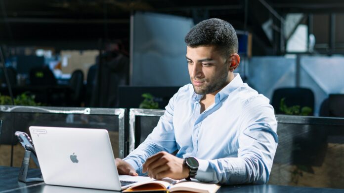 A man working on a laptop at a table