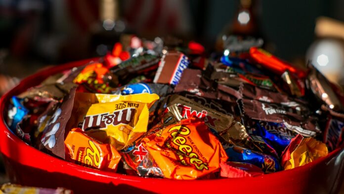 A red bowl filled with Halloween candy